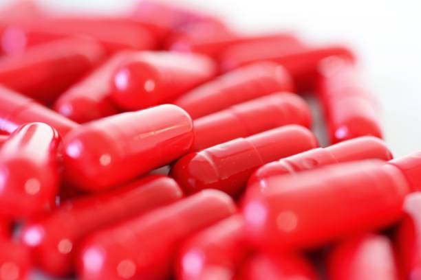 istock Heap of a red capsules macro 955664578