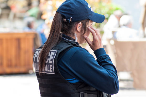 police women  observing in main place with headset Mulhouse - France - 5 May 2018 -  police women  observing in main place with headset mulhouse photos stock pictures, royalty-free photos & images