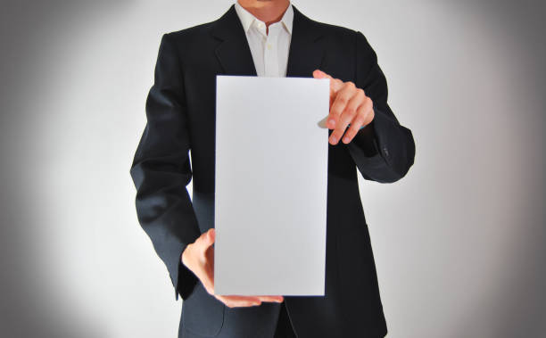 istock Businessman showing a blank page 955666582