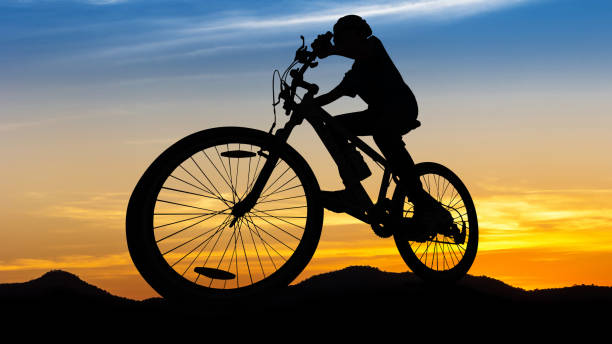 istock People cycling at the hill mountain twilight time 955669944