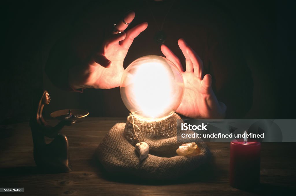Crystal ball.  The seance.  Fortune teller.  Future reading. Crystal ball and fortune teller hands. Divination concept. The spiritual seance. Future reading. Crystal Ball Stock Photo