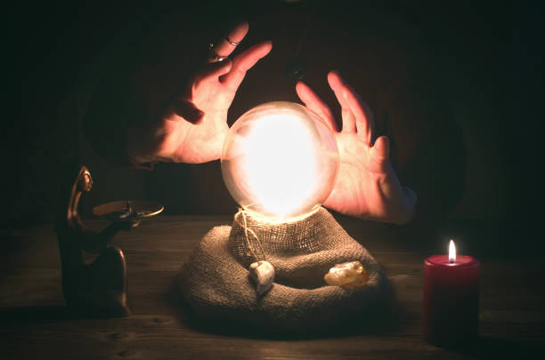 Crystal ball.  The seance.  Fortune teller.  Future reading. Crystal ball and fortune teller hands. Divination concept. The spiritual seance. Future reading. crystal ball photos stock pictures, royalty-free photos & images