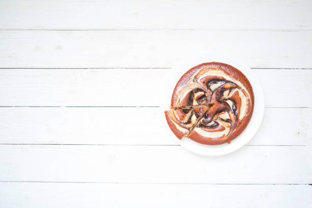Chocolate cake on white wooden background. Top view with copy space