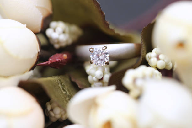istock Diamond ring and white tulip flower 955686000