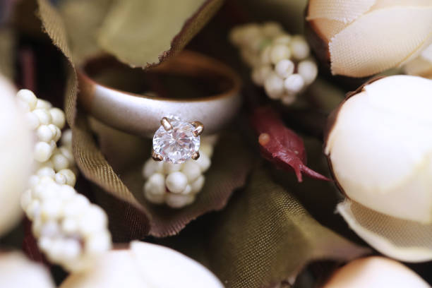 istock Diamond ring and white tulip flower 955686038