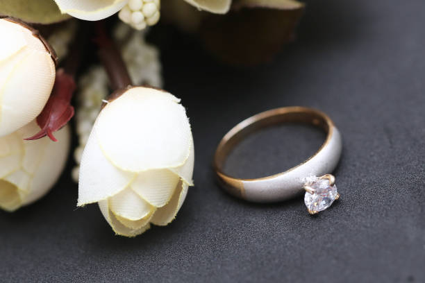 istock Diamond ring and white tulip flower 955686406