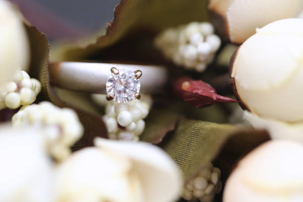 istock Diamond ring and white tulip flower 955686468
