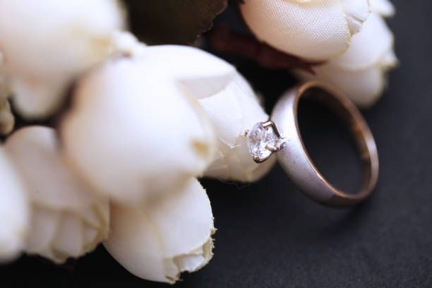 istock Diamond ring and white tulip flower 955686494