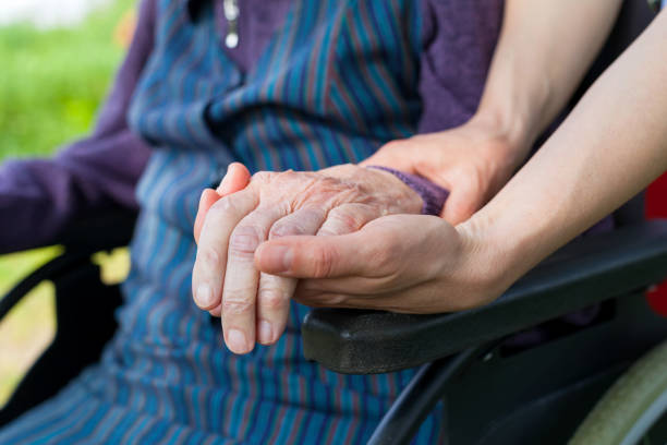 istock Holding hands - Parkinson disease 955690182