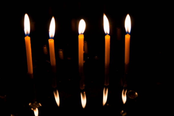 istock Prayer candles burning in a row inside Catholic church 955691346