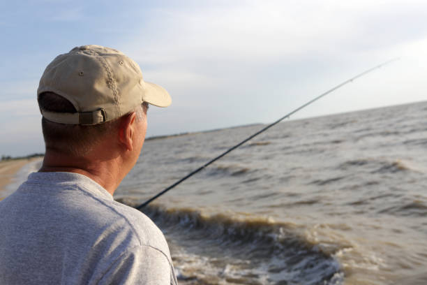 istock Senior man fishing at sunset 955696112