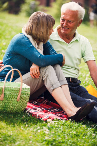 istock Happy Senior Couple Having Picnic In Town 955699204