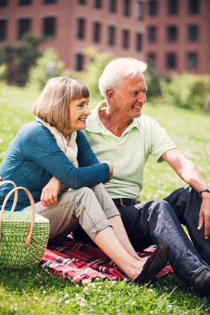 istock Happy Senior Couple Having Picnic In Town 955699220