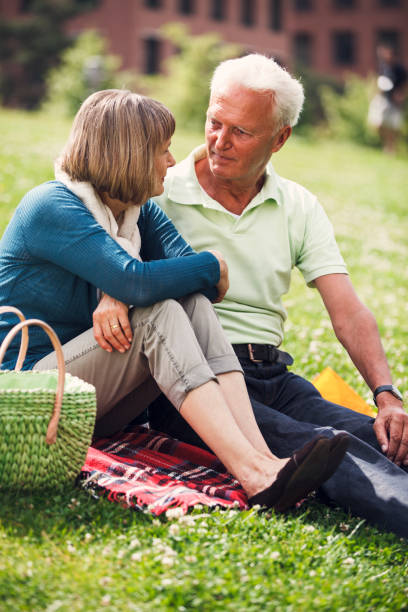istock Happy Senior Couple Having Picnic In Town 955699270