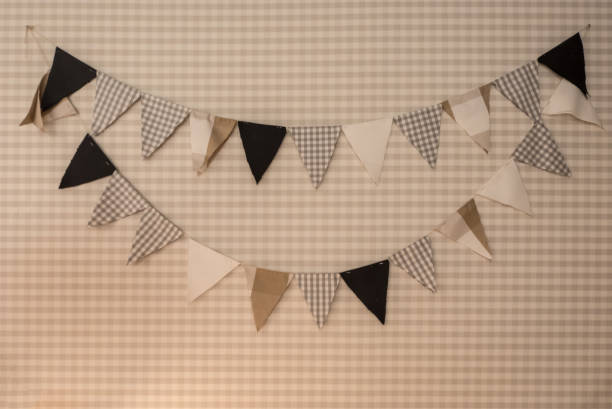 istock Decorated wall with triangle shape of fabric hanging on plaid background 955711412