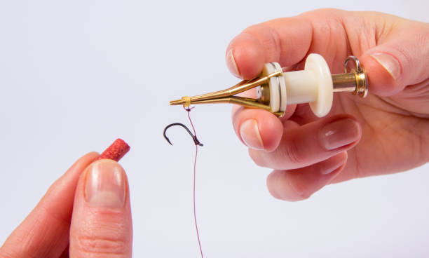 istock Fishing device for putting on the bait. New in the method feeder. 955723482