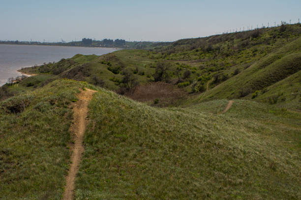istock a hiking trail on the green hills 955724838