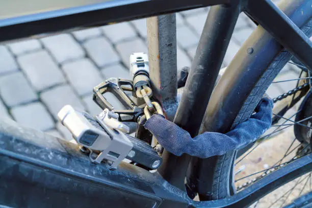 Electric bike, chained with several strong locks and chains to protect against thieves