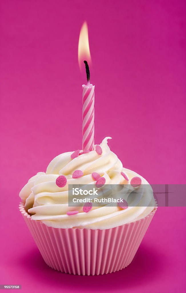 A pink birthday cupcake on a pink background Pink birthday cupcake against a magenta background Baked Stock Photo