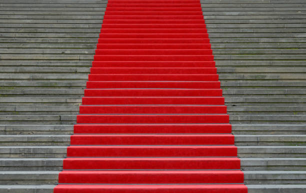 istock Red carpet over concrete stairs perspective 955748150