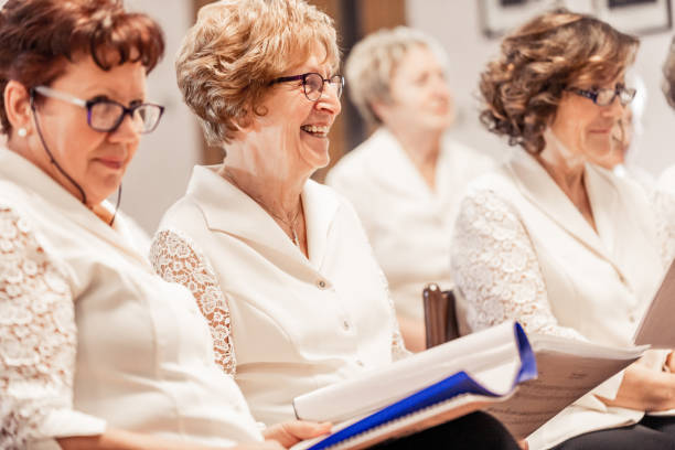 istock Senior Women Smiling At Choir Practice 955748808