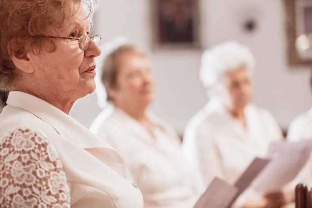 istock Senior Woman at Choir Practice 955748812