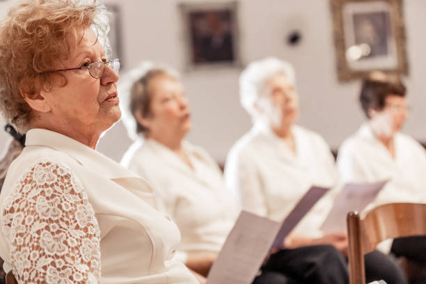 istock Senior Woman at Choir Practice 955748826
