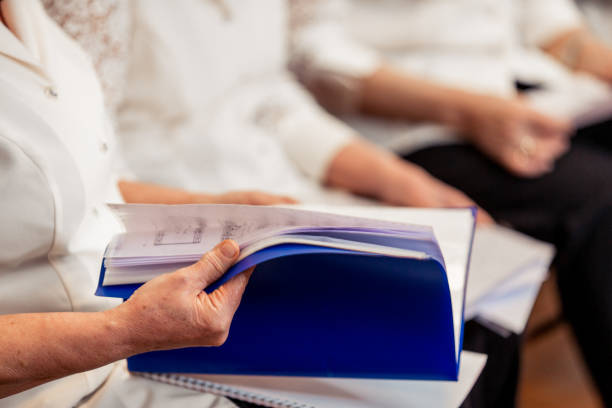 istock Senior Woman Browsing Thru a Music Sheet at Choir Practice 955748874