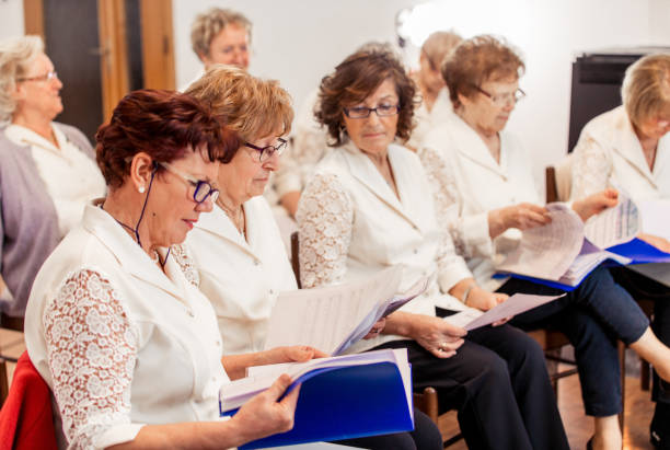 istock Senior Women at Choir Practice Browsing Thru their Music Sheets 955748876