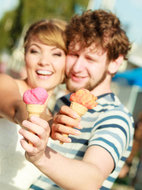 istock young couple eating ice cream outdoor 955749004