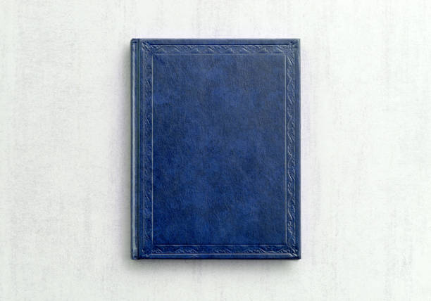 istock mock up book blue color on gray background close-up, top view 955749042