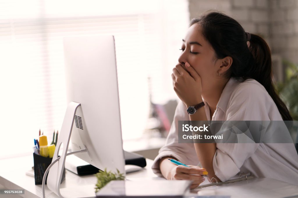 Businesswoman, yawned she was tired of working in an office. Tired Stock Photo
