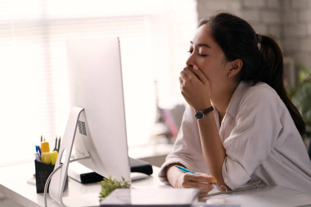 Businesswoman, yawned she was tired of working in an office. Businesswoman, yawned she was tired of working in an office. asian bored at work stock pictures, royalty-free photos & images