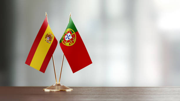 istock Spanish And Portuguese Flag Pair On A Desk Over Defocused Background 955753070