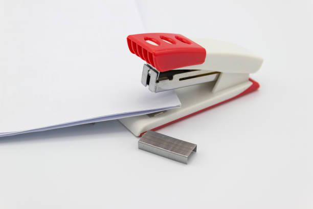 istock Pink stapler and paper 955756296