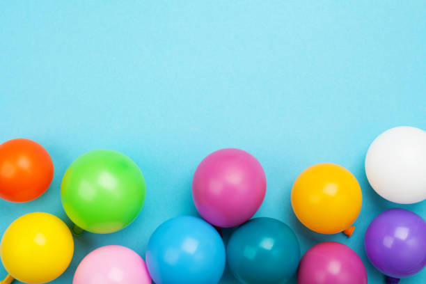 istock Colorful balloons on blue table top view. Festive birthday background. Flat lay style. 955756588