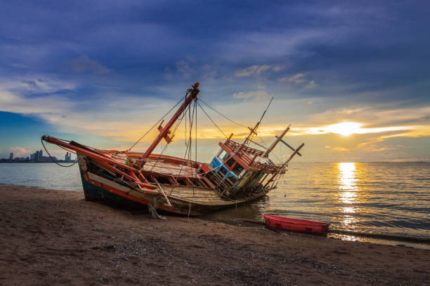 istock Wreck was left on the beach with the beautiful twilight sky. 955760066