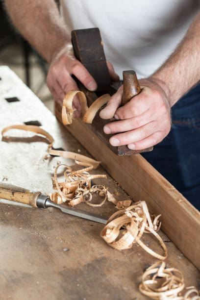 istock carpenter working with plane on wooden background 955760278