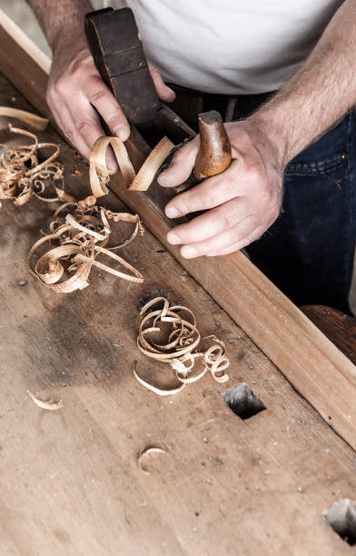 istock carpenter working with plane on wooden background 955760298
