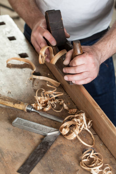 istock carpenter working with plane on wooden background 955760300