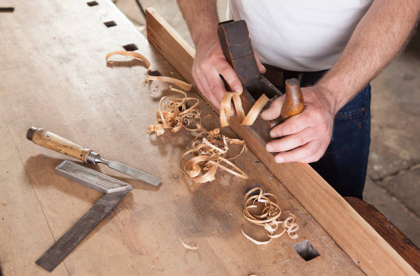 istock carpenter working with plane on wooden background 955760302