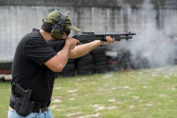 istock Man shooting on an outdoor shooting range, selective focus 955760326