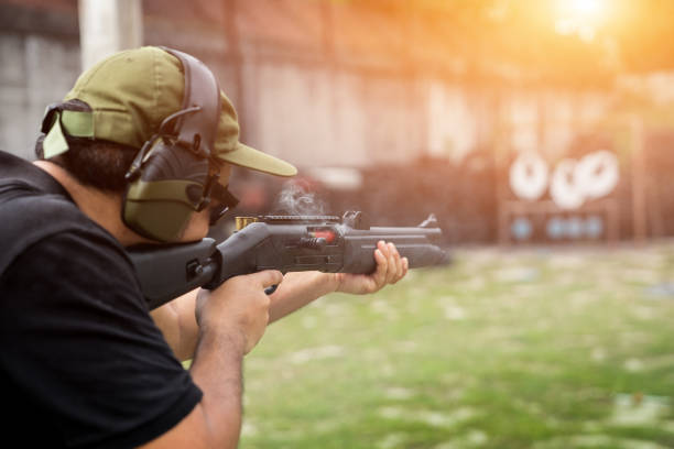 istock Man shooting on an outdoor shooting range, selective focus 955760412