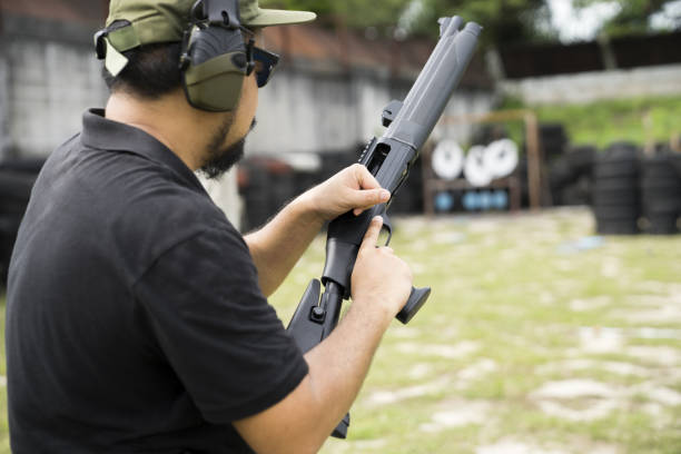 istock Man changing bullets in the shotgun. 955760438