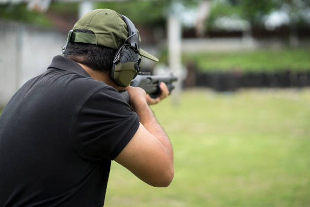 istock Man shooting on an outdoor shooting range, selective focus 955760498