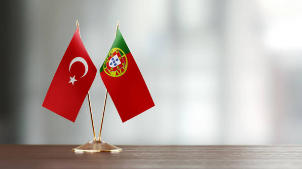 istock Turkish And Portuguese Flag Pair On A Desk Over Defocused Background 955763250