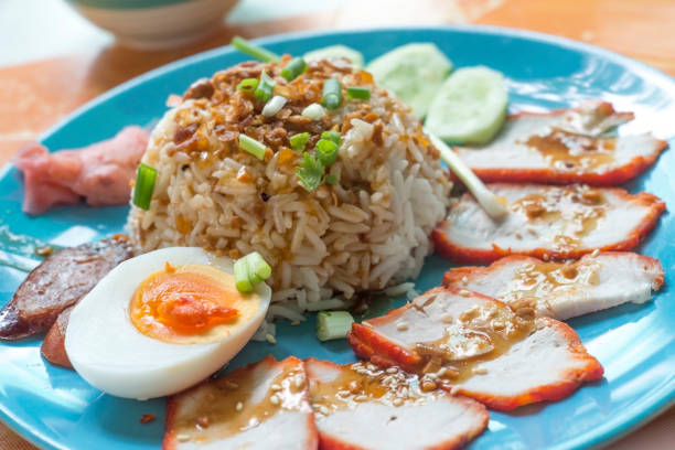 istock Rice with roasted red pork with egg and cucumber 955763850