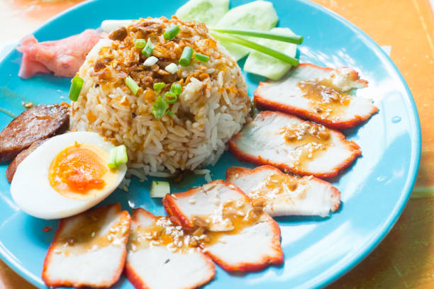 istock Rice with roasted red pork with egg and cucumber 955764510