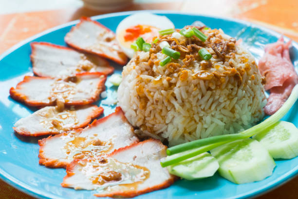 istock Rice with roasted red pork with egg and cucumber 955764658