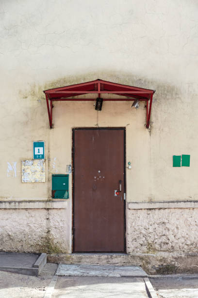 istock weathered brown door on old house wall 955765138